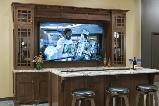 Large TV screen in wooden furniture in bar area